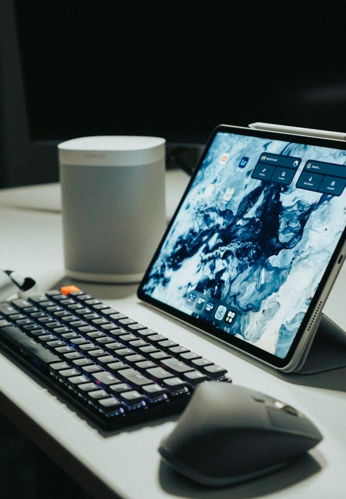 black-ipad-beside-black-computer-keyboard-on-white-table-iun3sq1fo4y